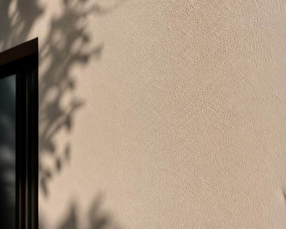 Macro detail of a fine sand-textured painted wall